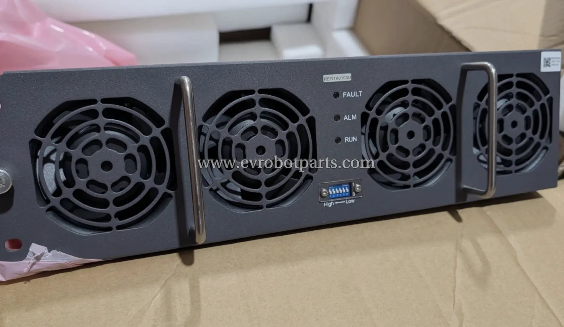 Rear view of the Infy Power REG1K0100U power supply unit, showing the cooling fans, status indicators (FAULT, ALM, RUN), and DC output terminals.