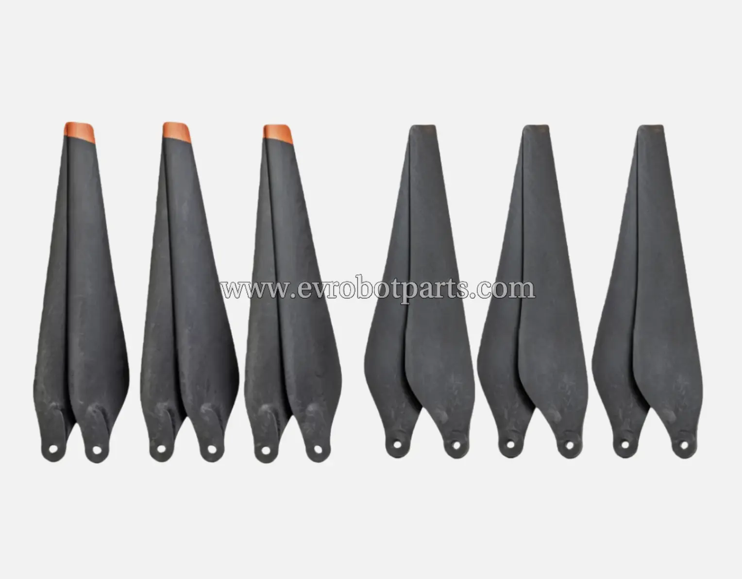 Set of six black drone propellers with orange tips arranged in two rows showing both clockwise and counter-clockwise rotation blades