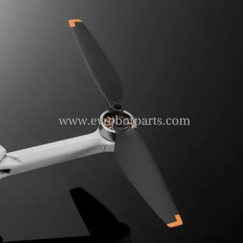 Close-up of DJI Mini 3 propeller mounted on drone motor with orange tip